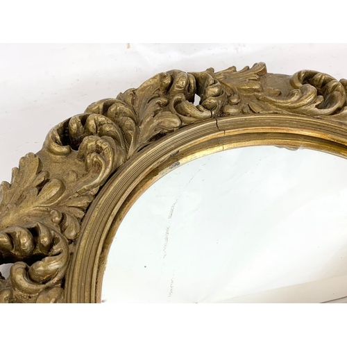 389a - A vintage ornate gilt framed mirror 46cm.