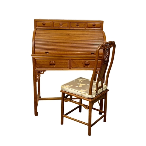 1133 - A Chinese teak role top cylinder desk and matching chair. 88.5 x 54.5 x 117cm.