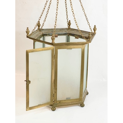 11 - A large Edwardian brass lantern with glass panels and stained glass panel base. 45 x 47cm
