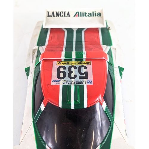 34 - A vintage battery operated remote controlled Lancia Stratos Turbo racing car. Car measures 35cm in l... 