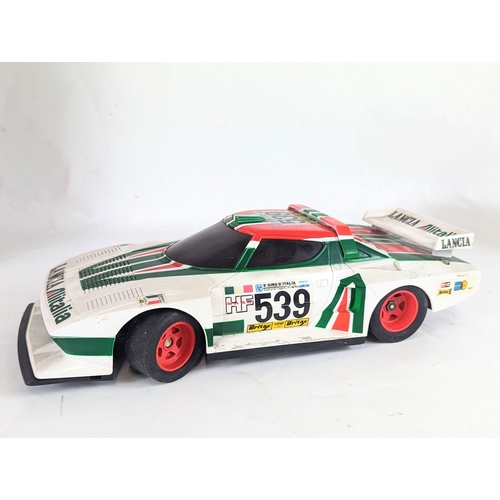 34 - A vintage battery operated remote controlled Lancia Stratos Turbo racing car. Car measures 35cm in l... 