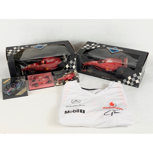 39 - A collection of signed model racing cars by Eddie Irvine. Minichamps model cars and signed Mercedes-... 