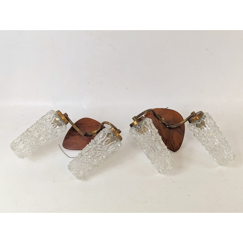 47 - A pair of 1960s, Mid Century, teak and brass wall lights with glass shades.