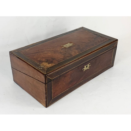 62 - A Victorian brass inlaid mahogany writing slope, with ink wells. 50 x 26 x 17cm closed.