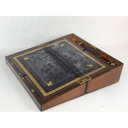 62 - A Victorian brass inlaid mahogany writing slope, with ink wells. 50 x 26 x 17cm closed.