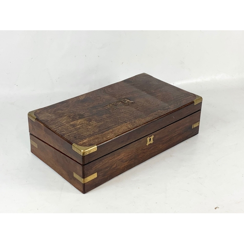 63 - A Victorian rosewood brass bound writing slope, with inkwells, etc. 45x25x13cm