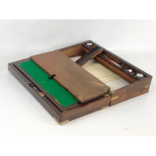 63 - A Victorian rosewood brass bound writing slope, with inkwells, etc. 45x25x13cm