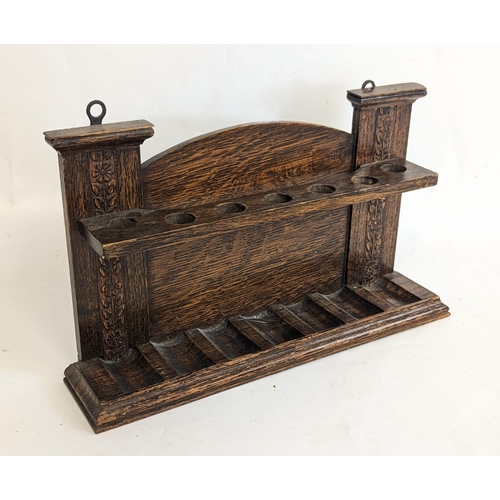 79 - An Edwardian oak smoker's pipe stand. 30x7x19.5cm