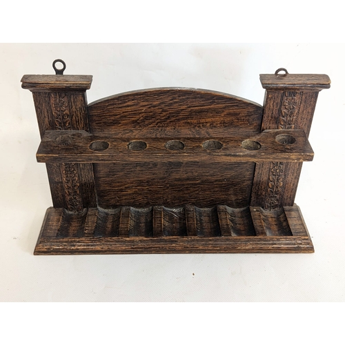 79 - An Edwardian oak smoker's pipe stand. 30x7x19.5cm