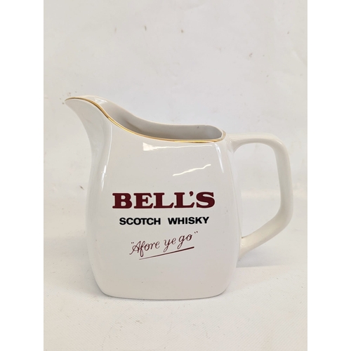 412 - A vintage Bell's Scotch Whisky water jug by Wade. 19x14.5cm