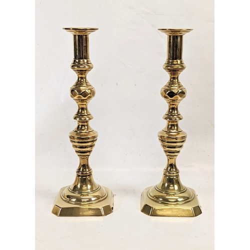 415 - A pair of large Victorian brass candlesticks. 35cm