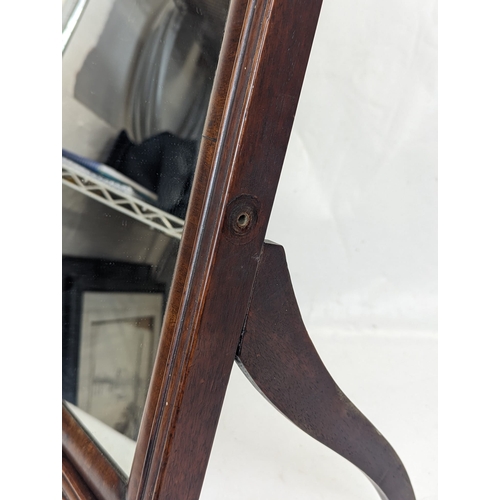 107 - A late Georgian mahogany dressing mirror. 57cm