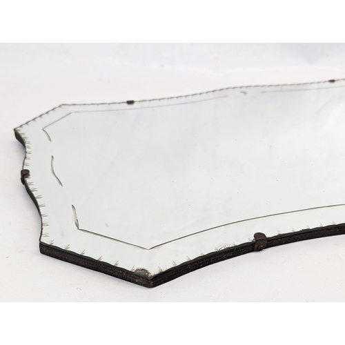 113 - A 1930s bevelled mirror. 68x38cm