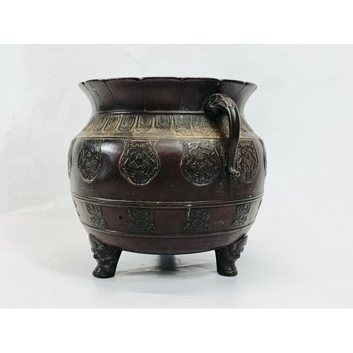 118 - A 19th century Chinese bronze 2 handled pot. 27 x 22cm