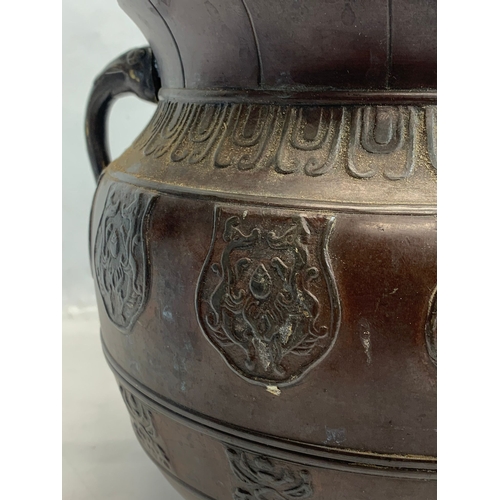 118 - A 19th century Chinese bronze 2 handled pot. 27 x 22cm