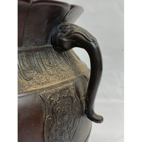 118 - A 19th century Chinese bronze 2 handled pot. 27 x 22cm