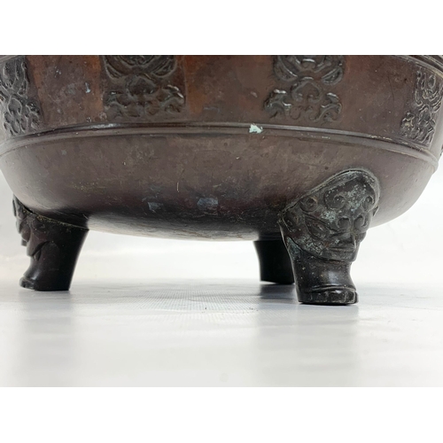 118 - A 19th century Chinese bronze 2 handled pot. 27 x 22cm