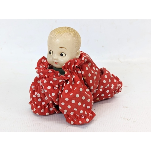 128 - 2 vintage baby doll toys. 1 a vintage wind-up toy, and other.