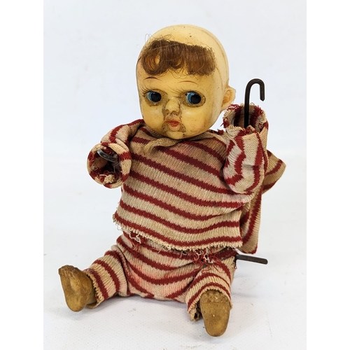 128 - 2 vintage baby doll toys. 1 a vintage wind-up toy, and other.