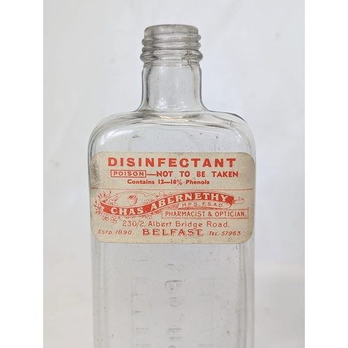 134 - Five early 20th century glass chemist bottles, from Abernethy Pharmacy on the Albert Bridge Road, Be... 