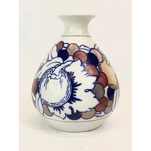 421 - A 1920’s Charlotte Rhead “Fruit” lustre vase for Burleigh Ware. 17cm