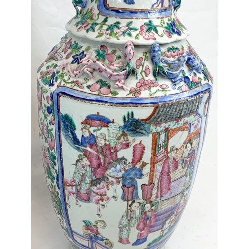 426 - A pair of large 19th century Chinese Famile Rose Canton Vases. 26 x 62.5cm.