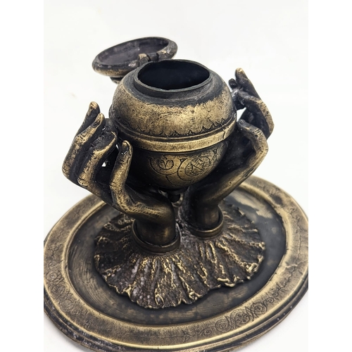 135 - An early 20th century bronze ink well. 16.5x14cm