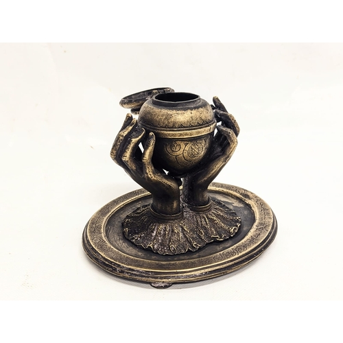 135 - An early 20th century bronze ink well. 16.5x14cm