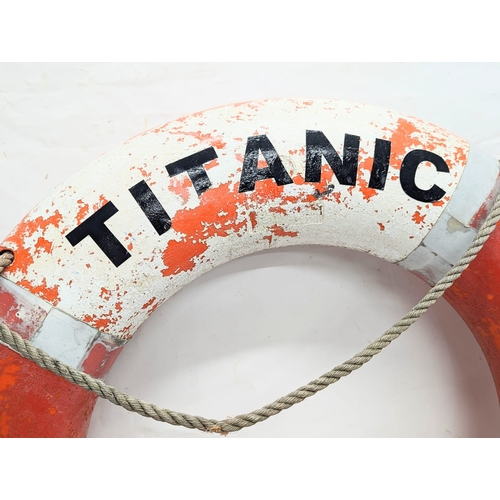 141 - A vintage life ring inscribed Titanic 1912. 75cm