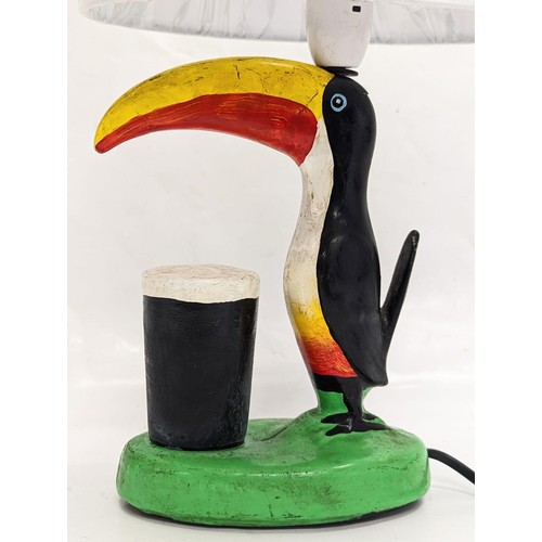 147 - A Guinness Toucan lamp. Including shade, 38cm