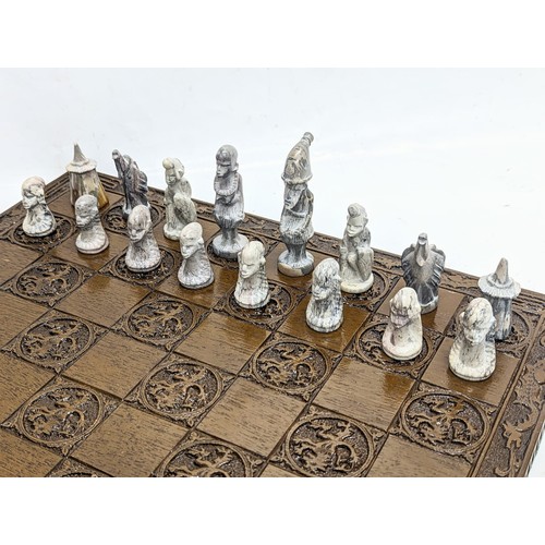 146 - A chess board with soap stone pieces.