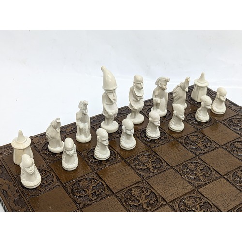 146 - A chess board with soap stone pieces.