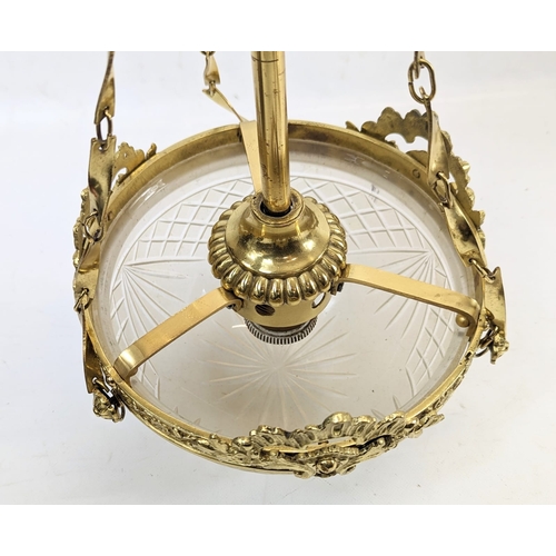 164 - An ornate brass light fitting with a glass shade. 20x50cm