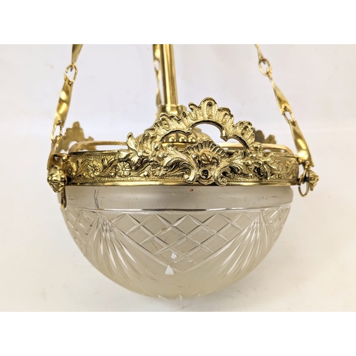 164 - An ornate brass light fitting with a glass shade. 20x50cm