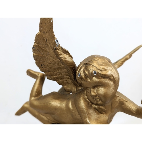 165 - A pair of early 20th century gilt cast iron cherubs. 21.5x28.5cm