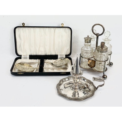 444 - A Victorian silver plated chamberstick, a cruet set and serving spoons in case.