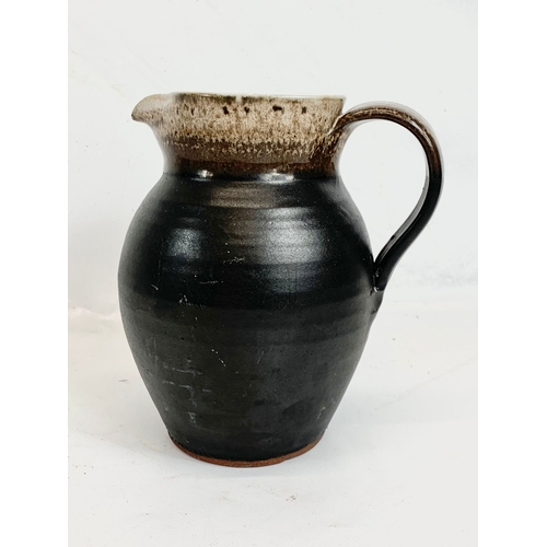 450 - A Shanagarry Studio pottery jug. 18cm