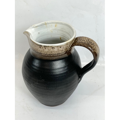 450 - A Shanagarry Studio pottery jug. 18cm