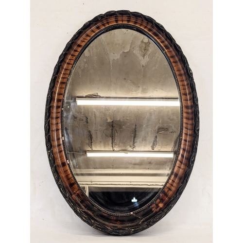 178 - A large Edwardian oval mirror. 51.5x79cm