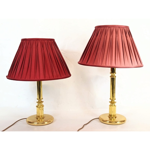 181 - A pair of brass table lamps. Tallest measures 38.5cm