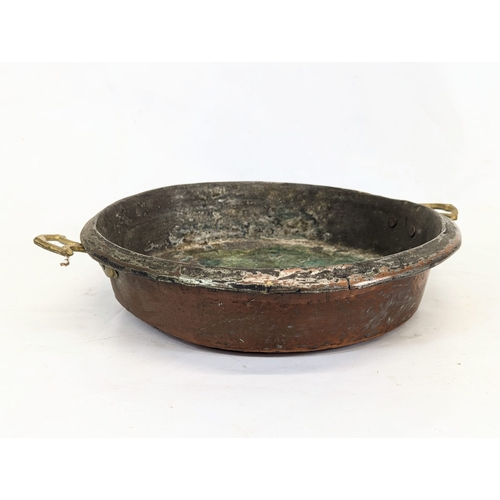 187 - 2 early 20th century copper pans. Largest measures 37cm