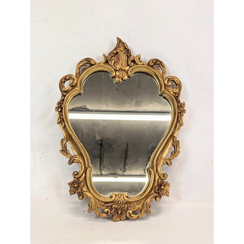 188 - An ornate gilt framed mirror. 33x46.5cm