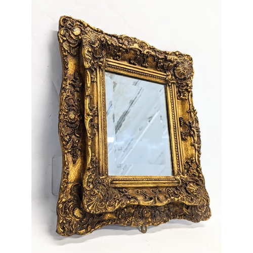 193 - An ornate gilt frame wall mirror, from Carvers & Gilders. 42x46cm