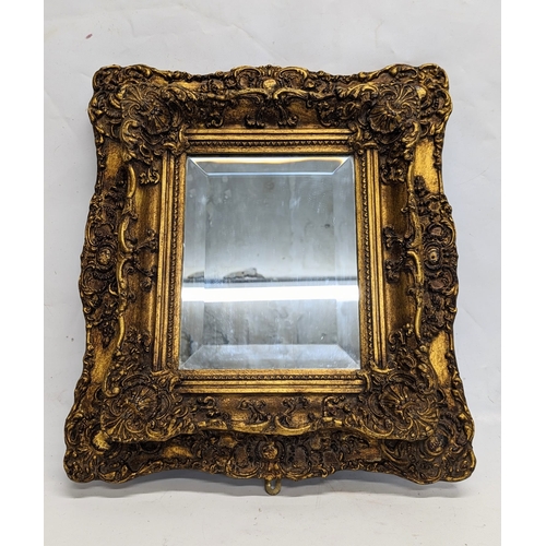 193 - An ornate gilt frame wall mirror, from Carvers & Gilders. 42x46cm