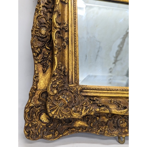 193 - An ornate gilt frame wall mirror, from Carvers & Gilders. 42x46cm