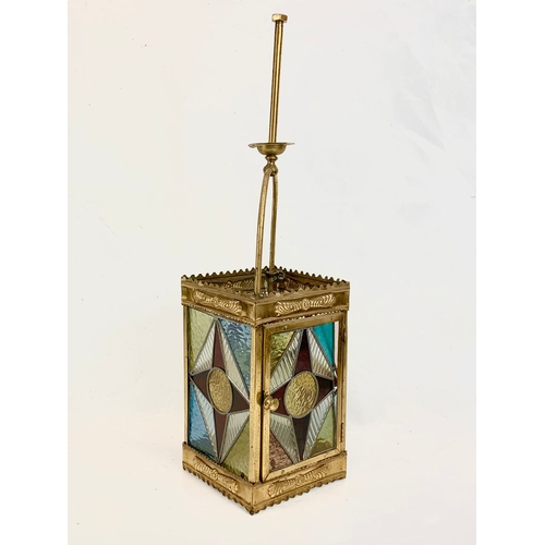 209 - A Victorian brass ceiling lantern with stained glass panels. 67cm