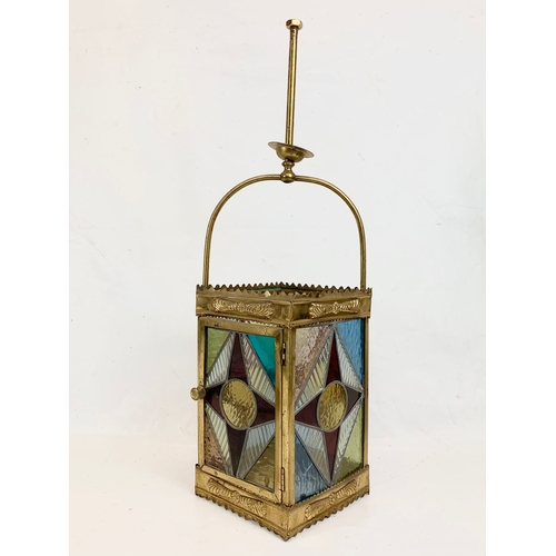 209 - A Victorian brass ceiling lantern with stained glass panels. 67cm