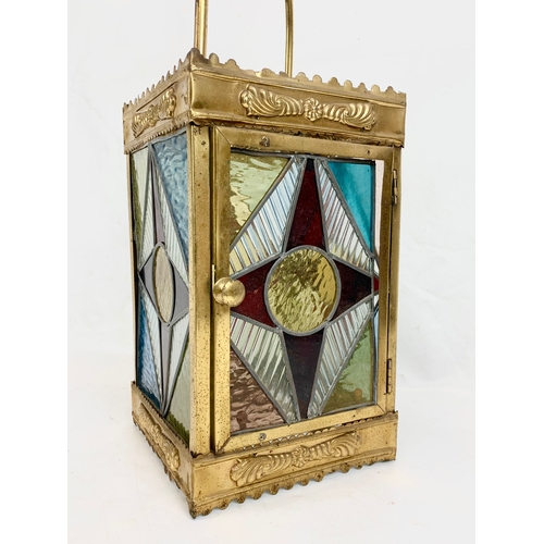 209 - A Victorian brass ceiling lantern with stained glass panels. 67cm