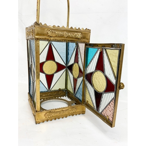 209 - A Victorian brass ceiling lantern with stained glass panels. 67cm