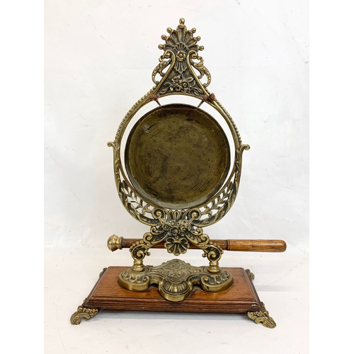 210 - A late Victorian ornate brass gong on oak stand. Circa 1890-1900. 29 x 43cm